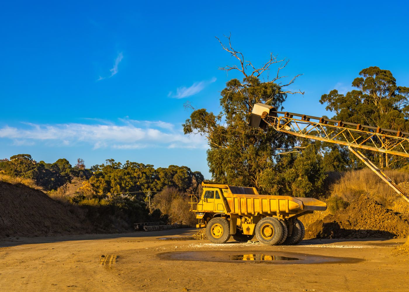 Dump truck body and hoist inspection: quarry heavy machinery. Illustrative stock photo.