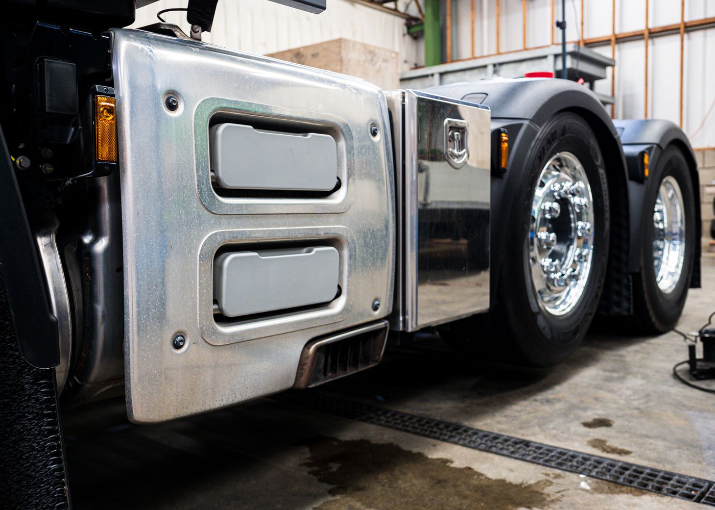 SHACMAN configuration check: close-up truck wheel inspection. Illustrative stock photo.